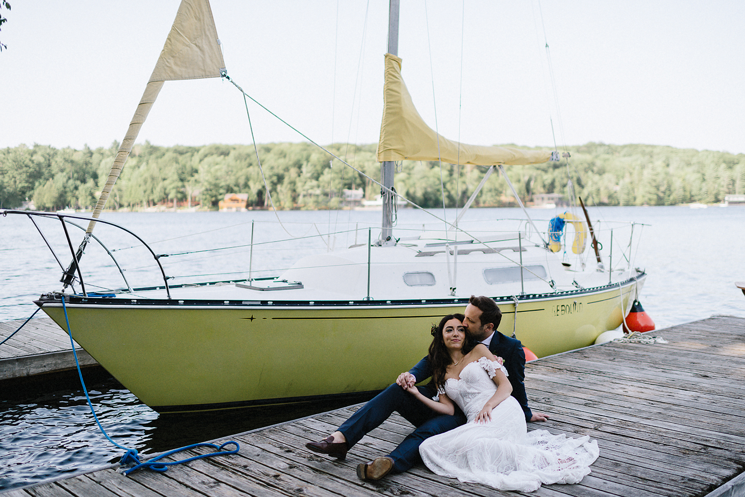 Muskoka-Cottage-Wedding-Photography-Photographer_Photojournalistic-Documentary-Wedding-Photography_Vintage-Bride-Lovers-Land-Dress_Rue-Des-Seins_Forest-Ceremony-Bride-and-Groom-Intimate-moment-on-Sailboat.jpg