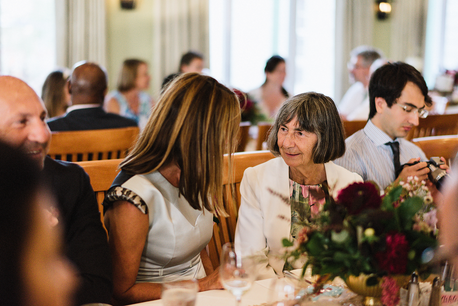 Muskoka-Cottage-Wedding-Photography-Photographer_Photojournalistic-Documentary-Wedding-Photography_Vintage-Bride-Sail-boat--Wedding-Details-Reception-Guests-Chatting.jpg