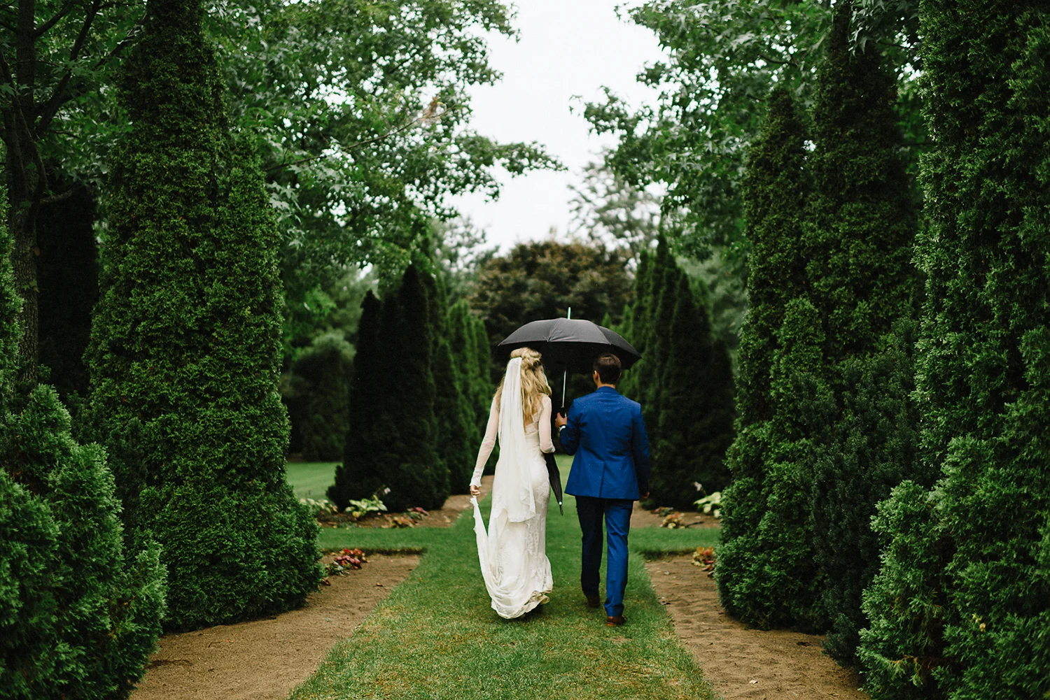 Best-Moody-Documentary-Wedding-Photography-Photojournalism-Vintage-Small-Town-Chapel-Wedding-Toronto-Ontario_Bridal-Portraits-Bride-and-Groom-outside-Garden-walking.jpg