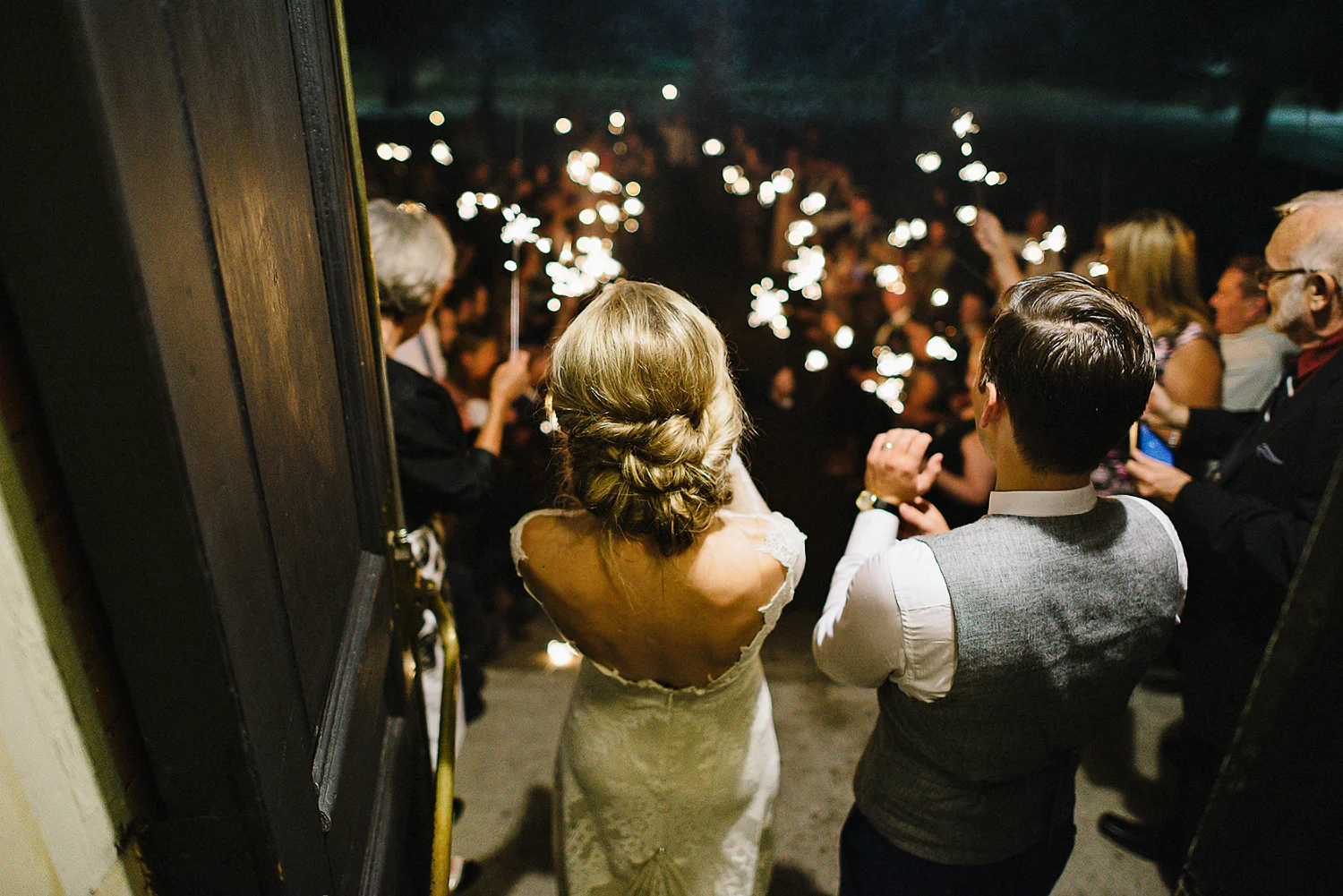 Best-Moody-Documentary-Wedding-Photography-Photojournalism-Vintage-Small-Town-Chapel-Wedding-Toronto-Ontario_Reception-Venue-bride-&-groom-sparkler-Exit-Wave.jpg