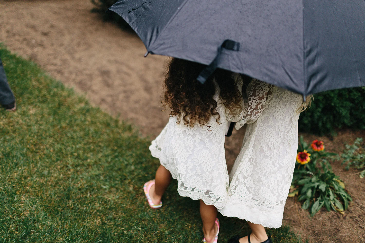 Best-Moody-Documentary-Wedding-Photography-Photojournalism-Vintage-Small-Town-Chapel-Wedding-Toronto-Ontario_Ceremony-Flower-Girls-hiding-from-rain.jpg