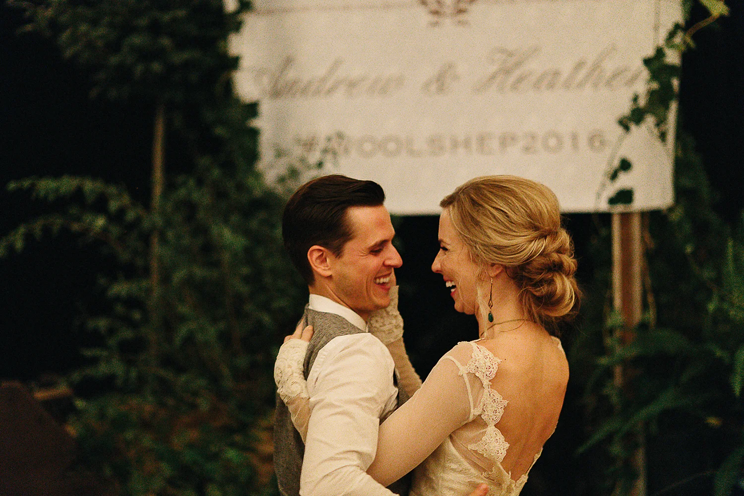 Best-Moody-Documentary-Wedding-Photography-Photojournalism-Vintage-Small-Town-Chapel-Wedding-Toronto-Ontario_Reception-Bride-and-groom-hugging-entrance.jpg