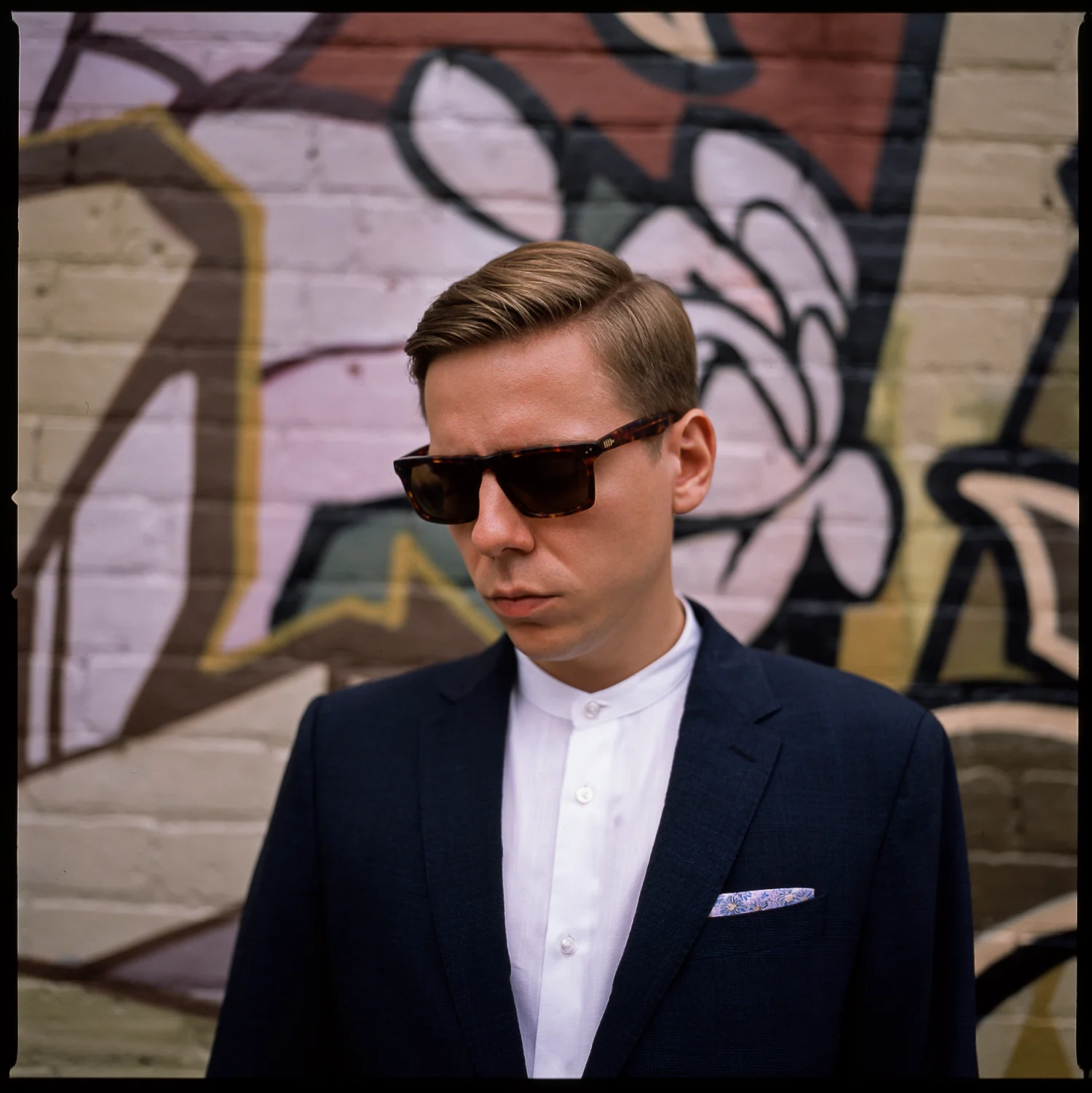 trendy-loversland-Groom-wearing-slim-fitted-suit-with-no-tie-kensington-Market-Bridal-portraits-Analog-Film-Best-Wedding-Photographers-Toronto.jpg