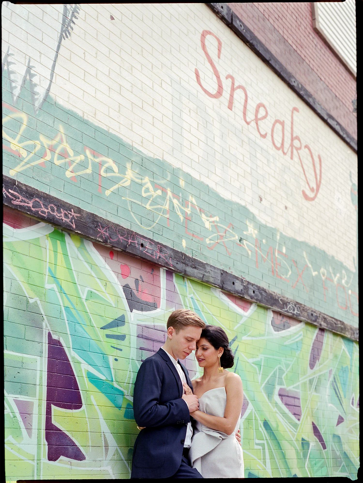 Best-Documentary-Wedding-Photographers-Toronto-Analog-Film-Photographer-Downtown-Kensington-Market-City-Bride-Bridal-Jumpsuit-Style-Inspiration-Graffiti-Vibes-Cool-Bride-and-Groom-Portrait-Sneeky-Dees.jpg