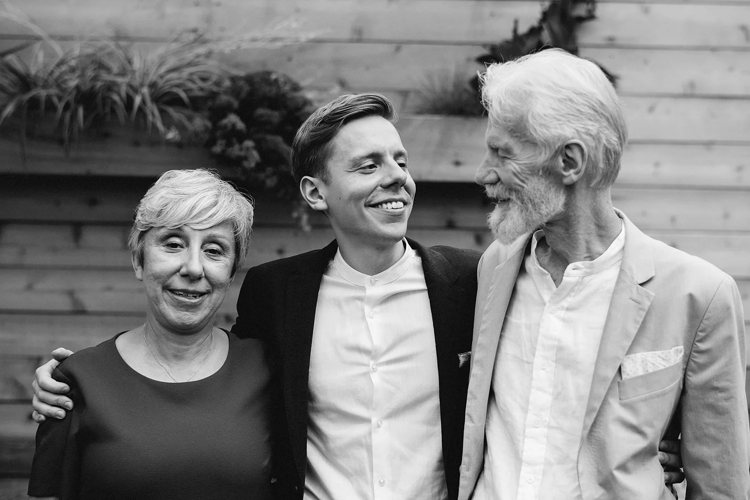 film-analog-photography-toronto-film-wedding-photographers-alternative-reception-bar-pray-tell-cocktail-hour-reception-on-the-patio-candid-groom-with-parents.jpg