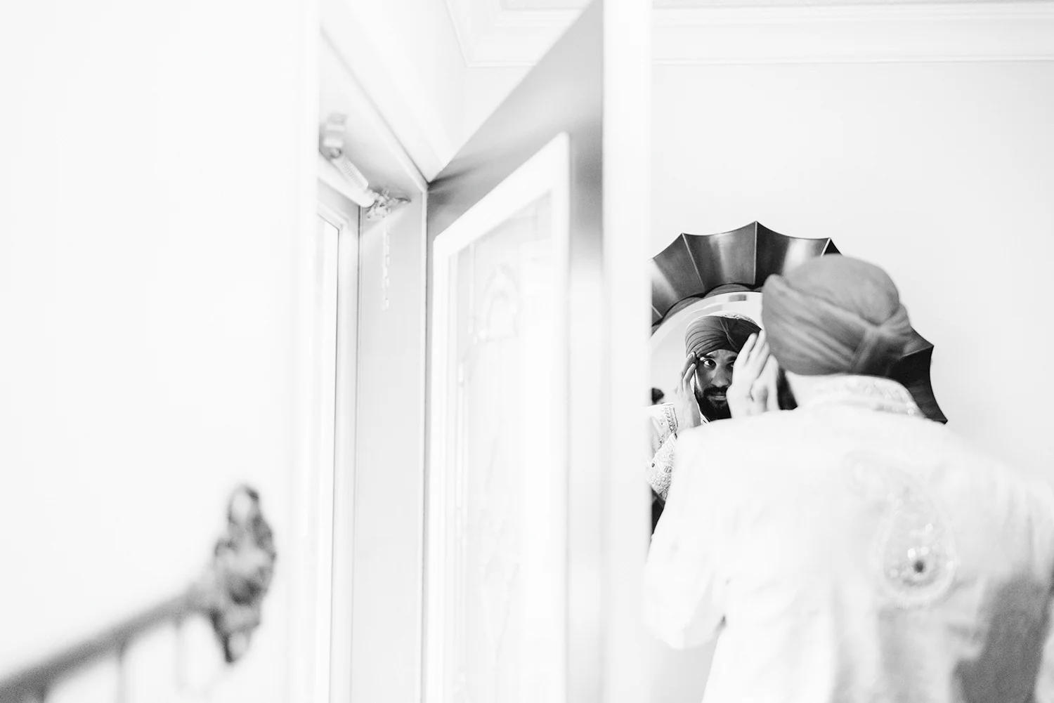 Toronto-Photojournalism-wedding-photographers-3B-Photography-Candid-Documentary-Film-Photography-Analog-Ontario-Hamilton-Port-Perry-Venue-Groom-Getting-Ready-putting-on-turban-sikh-ceremony-traditional-garments-reflection.jpg
