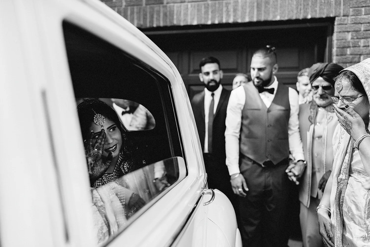 Toronto-Photojournalism-wedding-photographers-3B-Photography-Candid-Documentary-Film-Photography-Analog-Ontario-Hamilton-Port-Perry-Venue-Groom-Getting-Ready-putting-on-turban-sikh-ceremony-emotional-as-she-leaves-in-vintage-car.jpg