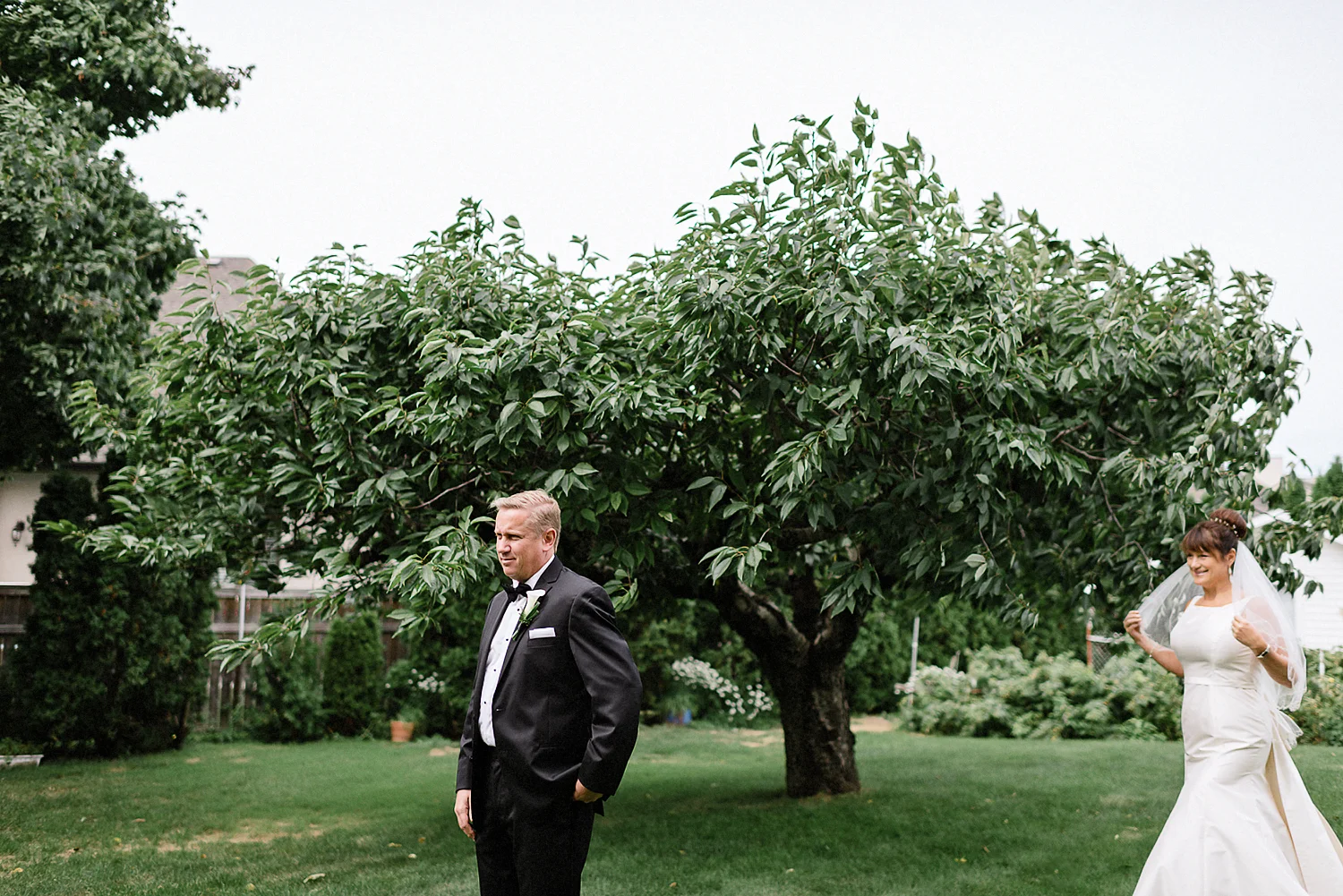 Best-Moody-Documentary-Wedding-Photographers-in-Toronto-Canada-Vintage-Photojournalistic-Wedding-photography-Epic-Moody-Cinematic-First-Look-in-Brides-Parents-backyard-by-cherry-tree.jpg