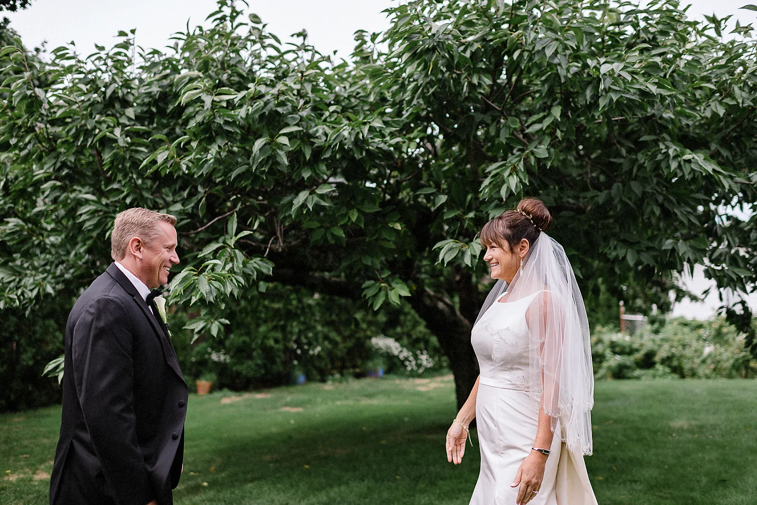 Best-Moody-Documentary-Wedding-Photographers-in-Toronto-Canada-Vintage-Photojournalistic-Wedding-photography-Epic-Moody-Cinematic-First-Look-in-Brides-Parents-backyard-by-cherry-tree-.jpg