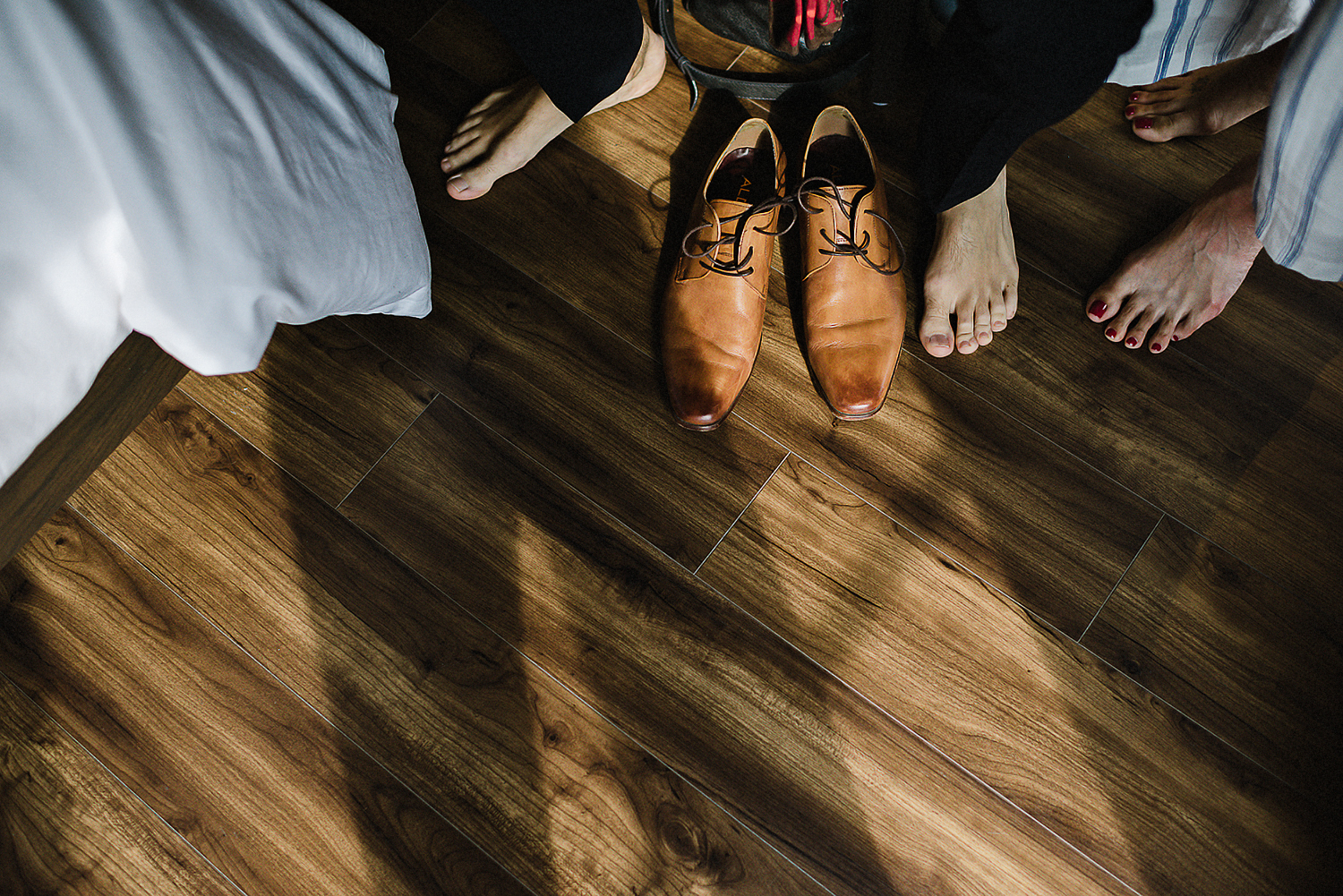 19-514-Toronto-Wedding-at-the-Broadview-Hotel-Vintage-Bride-and-Groom-Wedding-Details-Old-School-Telephone-Best-Wedding-Photographers-Toronto-Junebug-Weddings-Candid-Genuine-Moments-Groom-getting-ready-putting-on-shoes.jpg