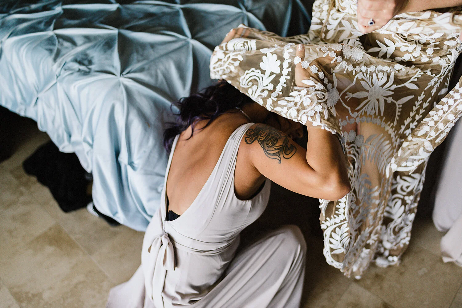 379-destination-wedding-cabo-san-lucas-ventanas-private-residence-alternative-toronto-wedding-photographer-bride-getting-ready-tattooed-bride-dressing-with-help-from-bridesmaids-candid.JPG