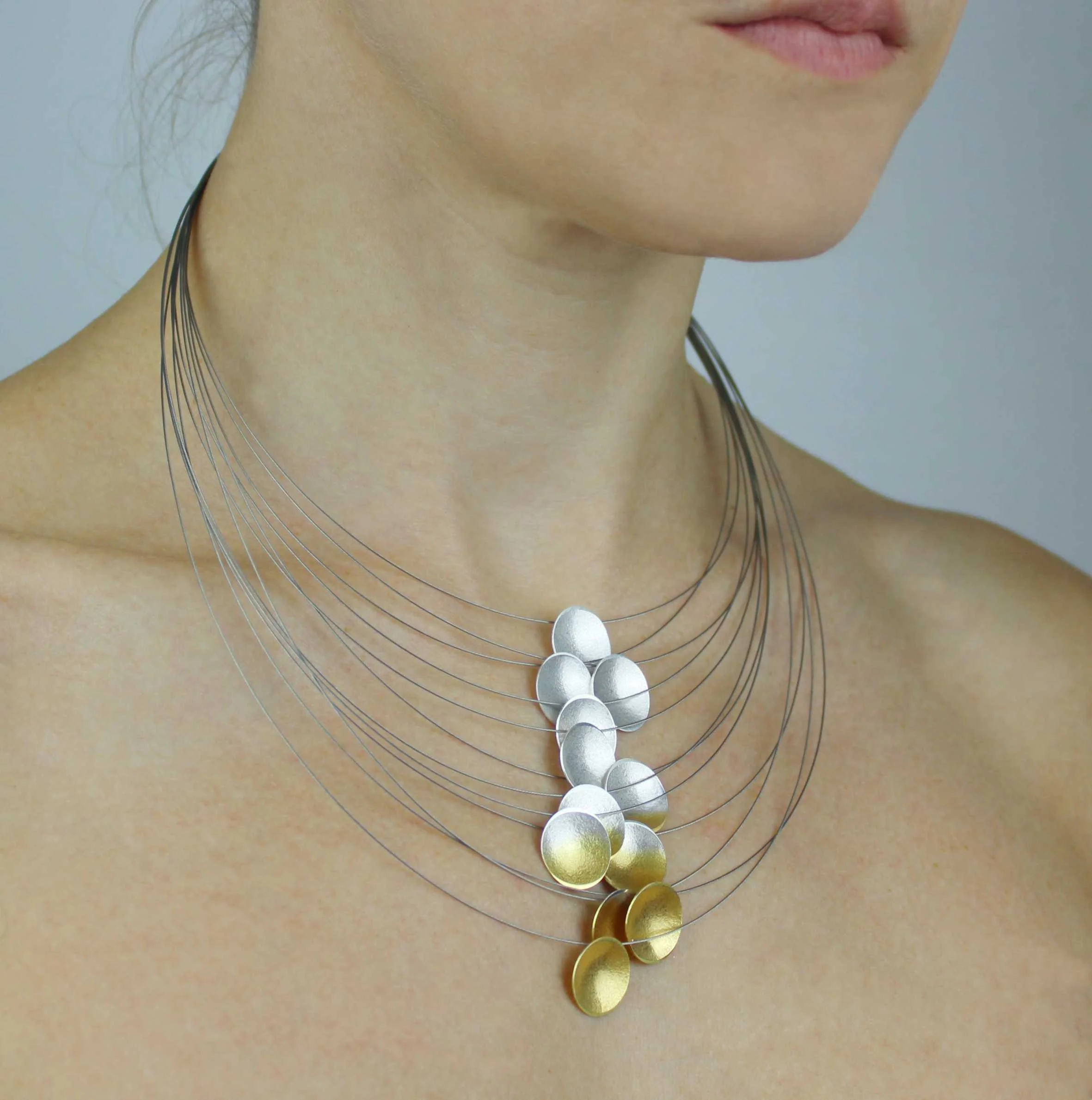 Silver and gold necklace on a model