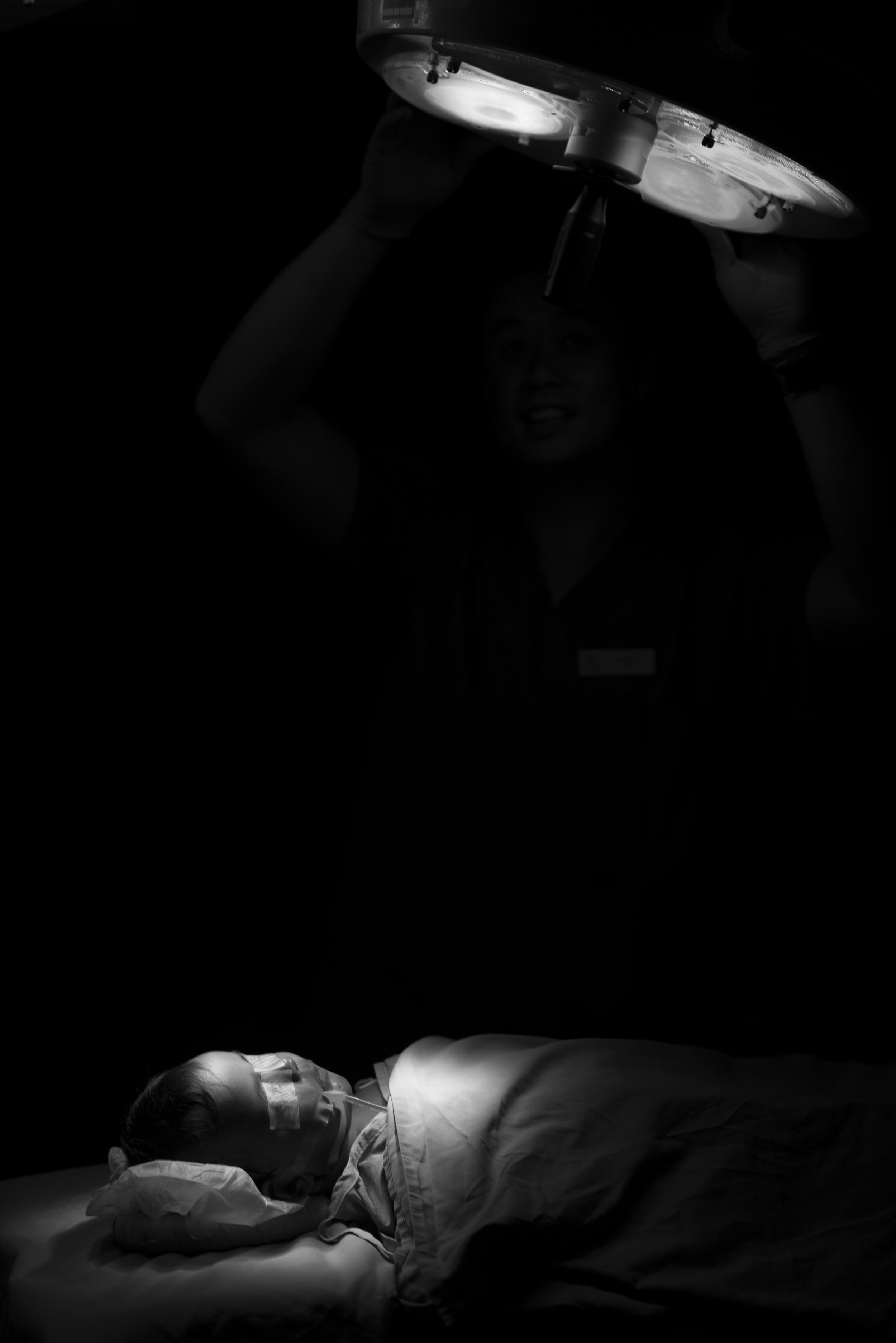  Tonga.  A young boy lies asleep in the dark waiting for surgery, whilst the team prepares out of frame. In this moment, the only sound is that of his heartbeat on the monitor. The 'stage' of a theatre is one I've become familar over the years, but I
