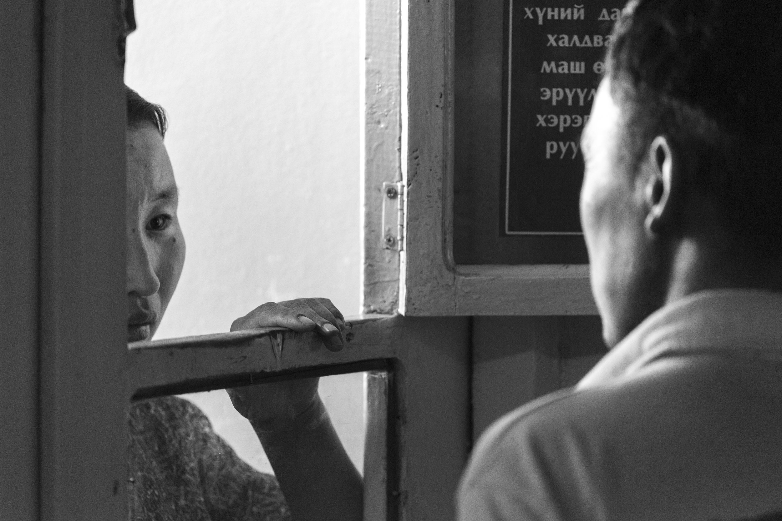  Moron, Mongolia  A scene that plays out every day. The hospital staff greet concerned family members through this wooden hatch, to deliver either the good news or the bad. There is an intimacy here that I watched several times, a respect for the doc