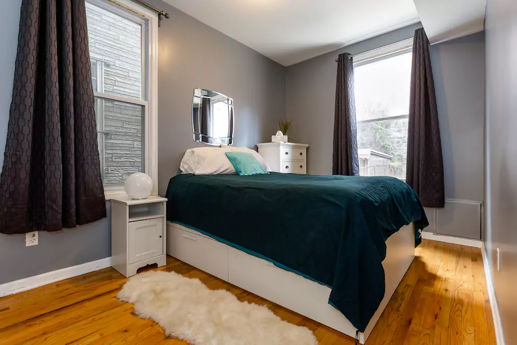 14 Room with queen bed, side table, dresser, large closet with hangers.png