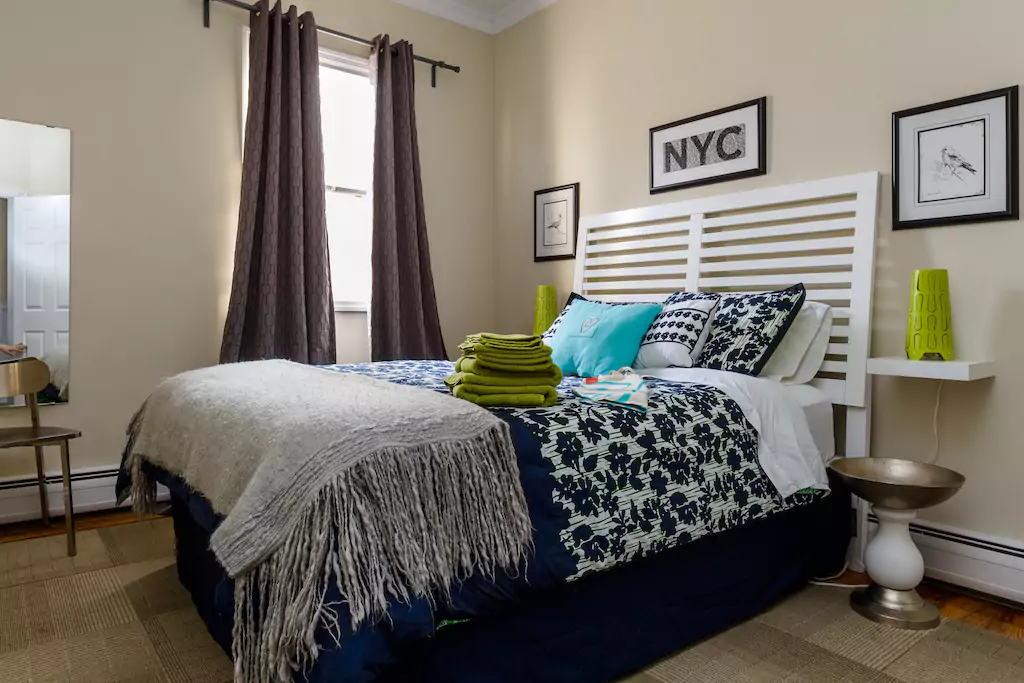 03 Large bright bedroom with queen bed.png