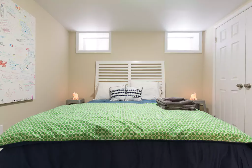 16 Queen bed at front of apartment.png