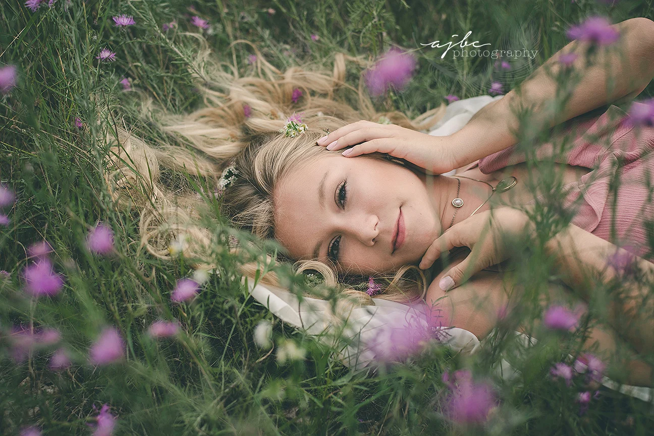 senior photoshoot in a field of flowers .jpg