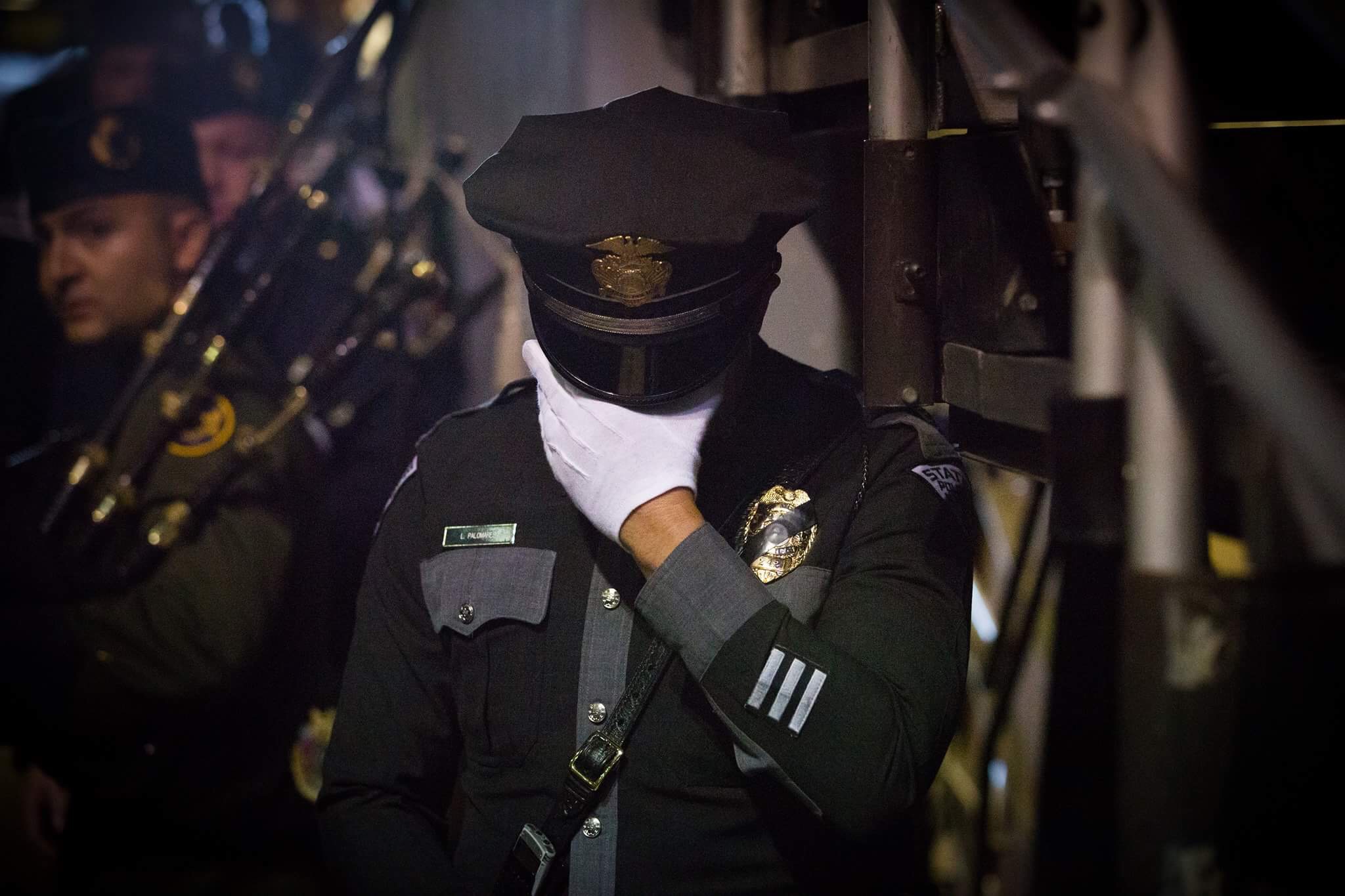 A New Mexico State Police Officer bows his head at the end of the memorial service for slain Hatch, NM police officer José Chavez at the Pan American Center in Las Cruces, NM, Sunday, August 21, 2016