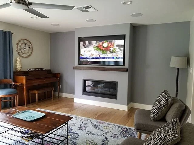 65" Samsung TV recessed above a fireplace with in-ceiling klipsch pro level speakers for 5.1 surround. This install also has a 10 inch subwoofer hidden under the floor! #samsung #klipsch #polk #audio #mancave #mancaveamerica #custom #hometheater
