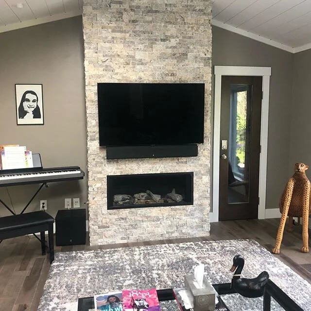 Samsung Tv Over Stone Fireplace with passive Origin Acoustics Soundbar.