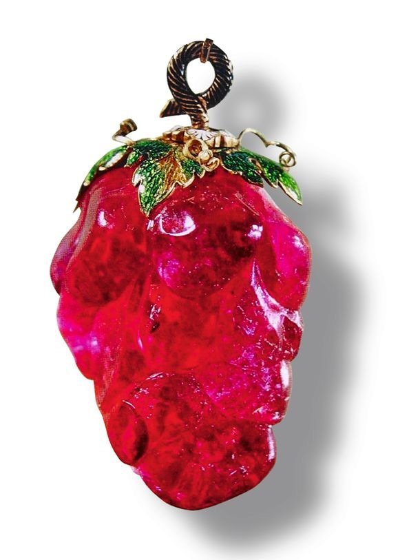 “Caesar’s Ruby” c. 1745 a 52 ct. rubellite tourmaline, with enameled 18 karat gold leaves and silver bail.