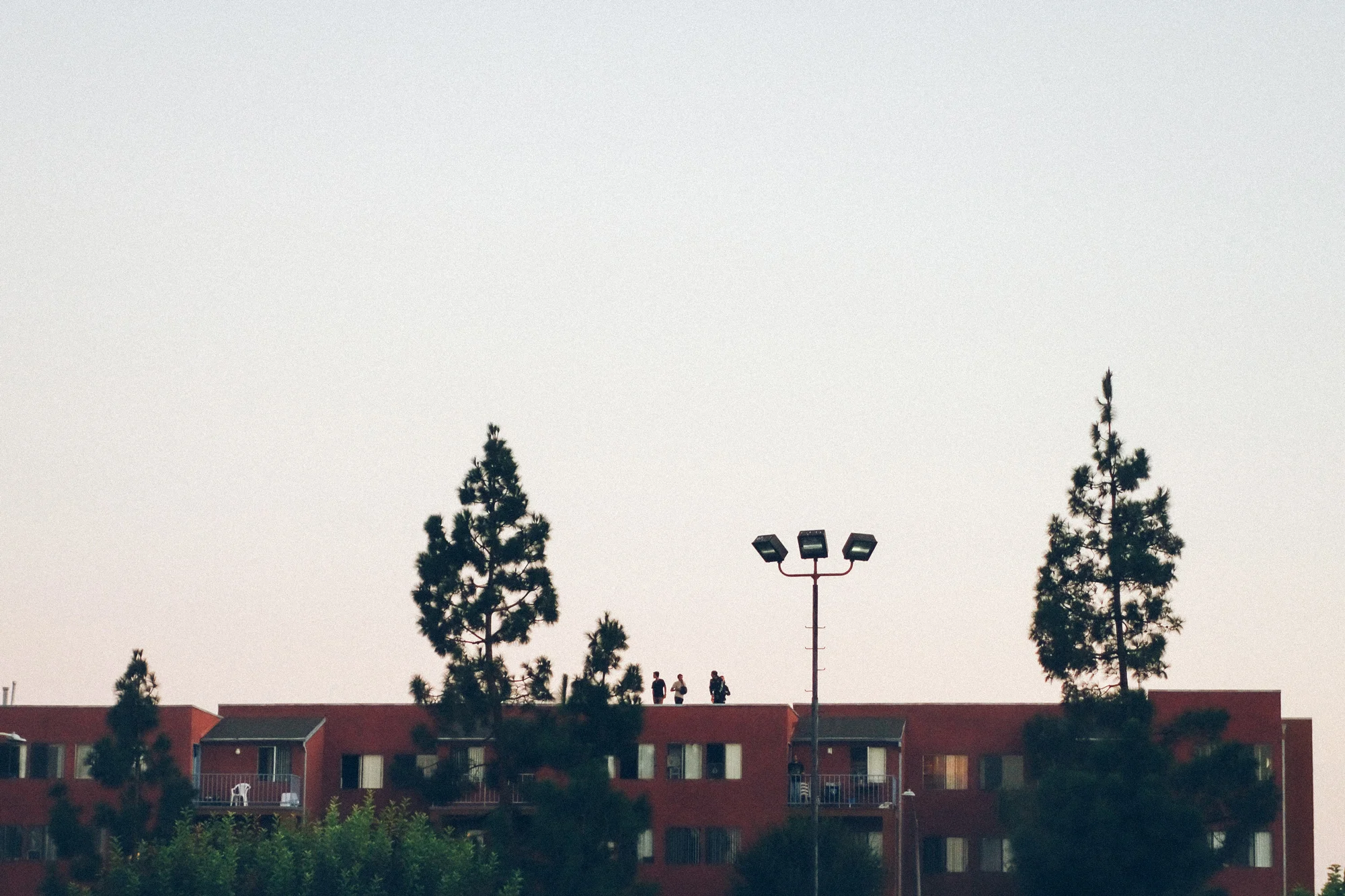 These kids took in Flume's set from the apartment rooftop next to the main stage.