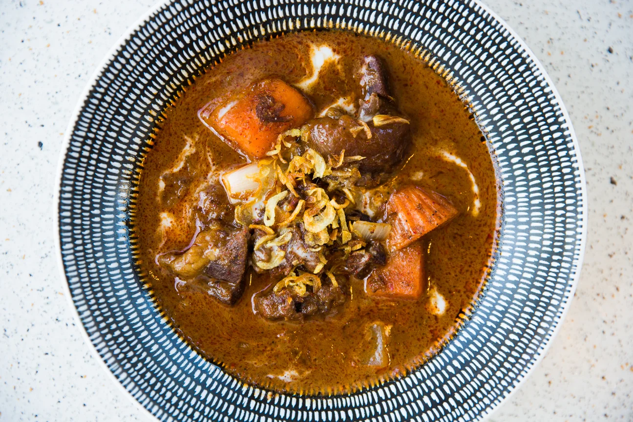 Braised ox cheek massaman curry with sweet potatoes and onion