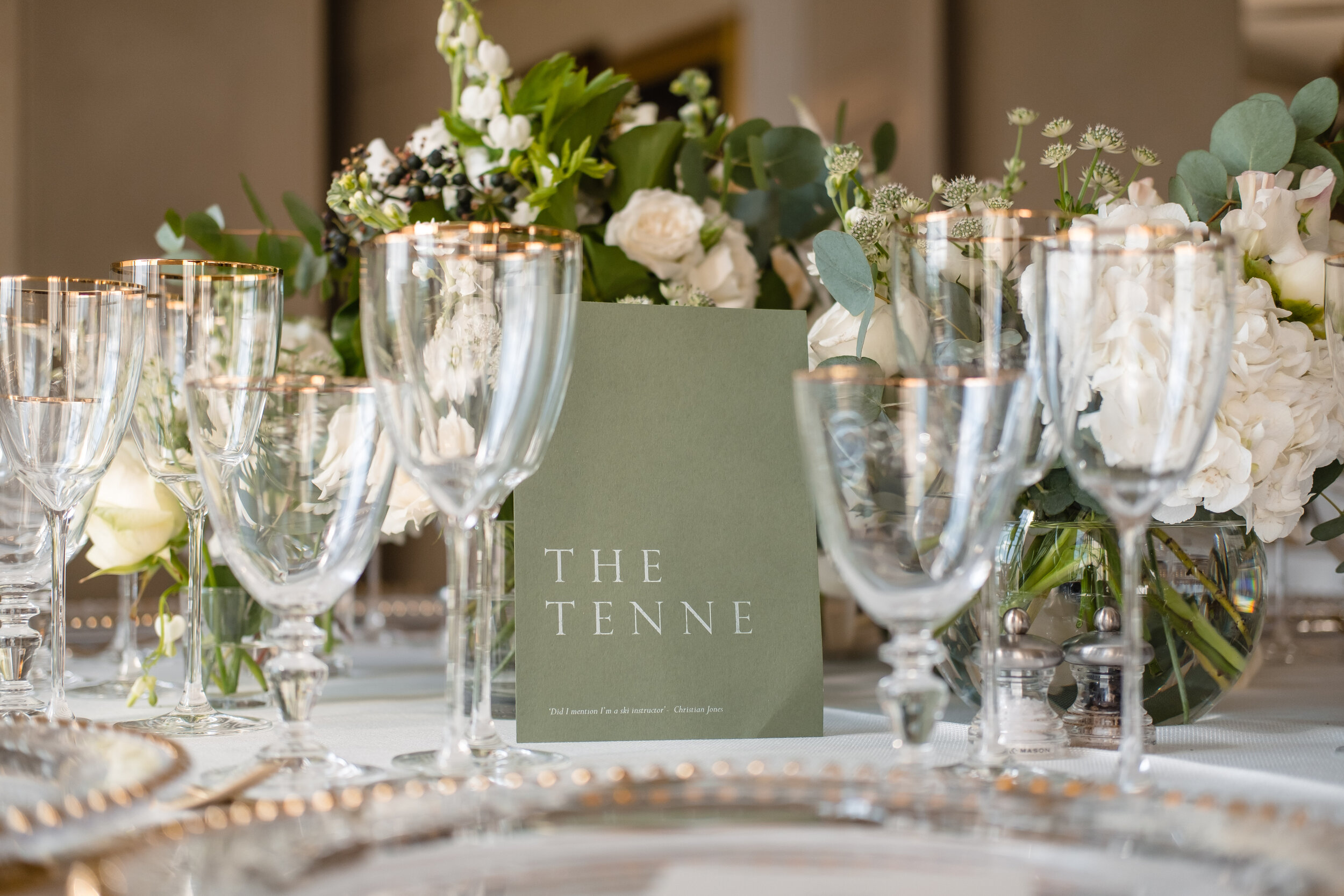 gold rimmed glassware on a table set for a wedding breakfast