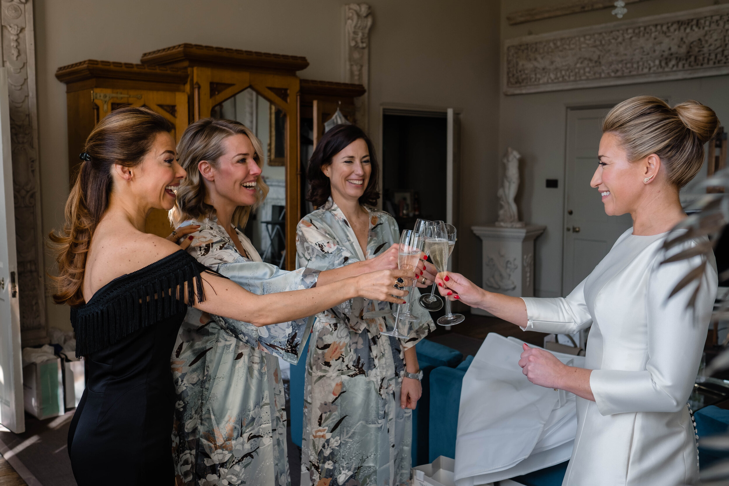 bride and bridesmaids toasting with champagne