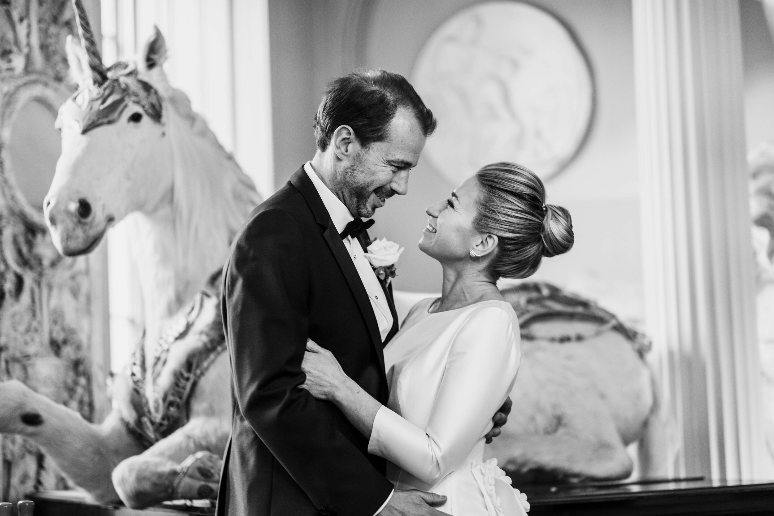 Aynhoe Park wedding photographer bride and groom in front of taxidermy unicorn