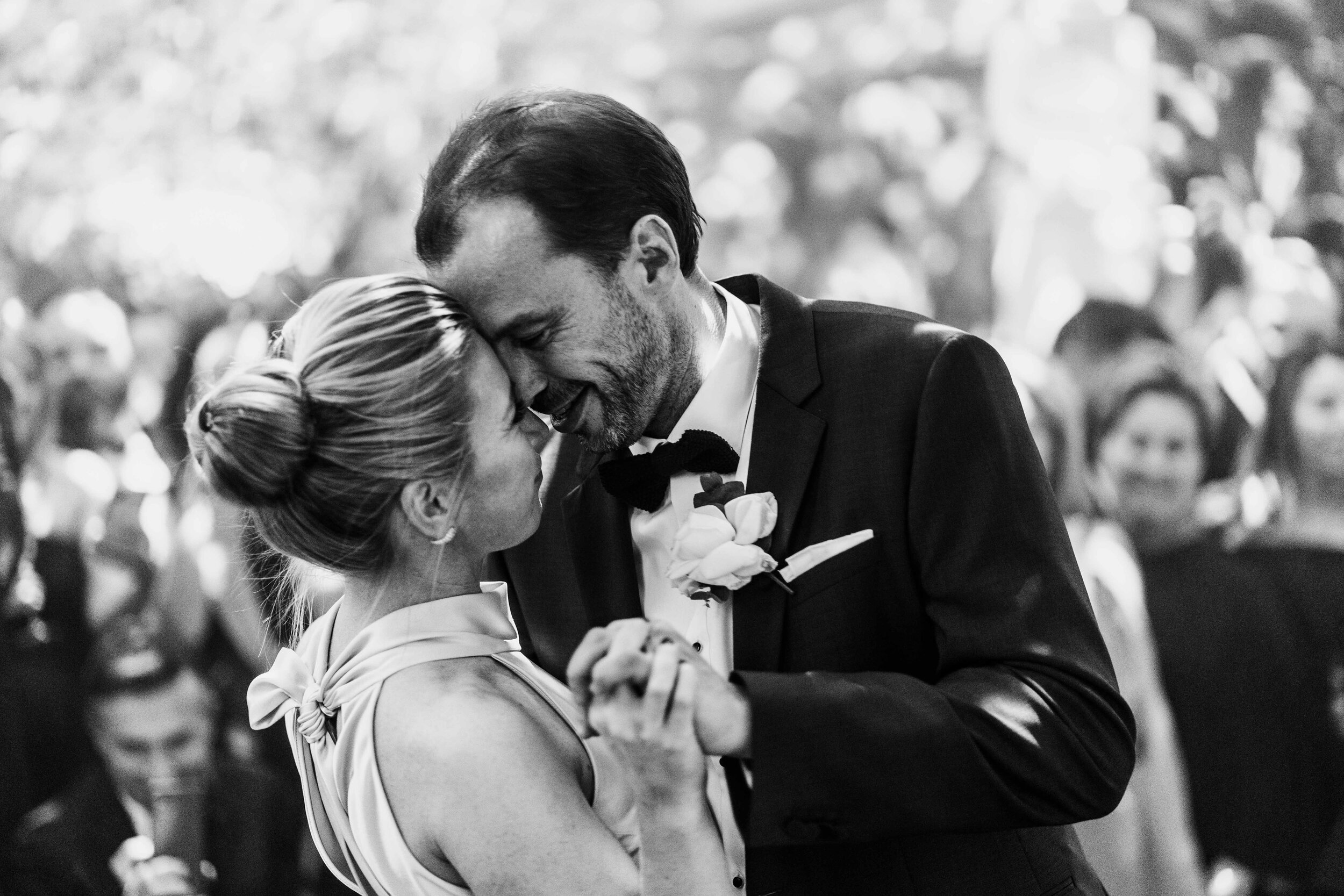 close up shot in black and white of bride and groom dancing 