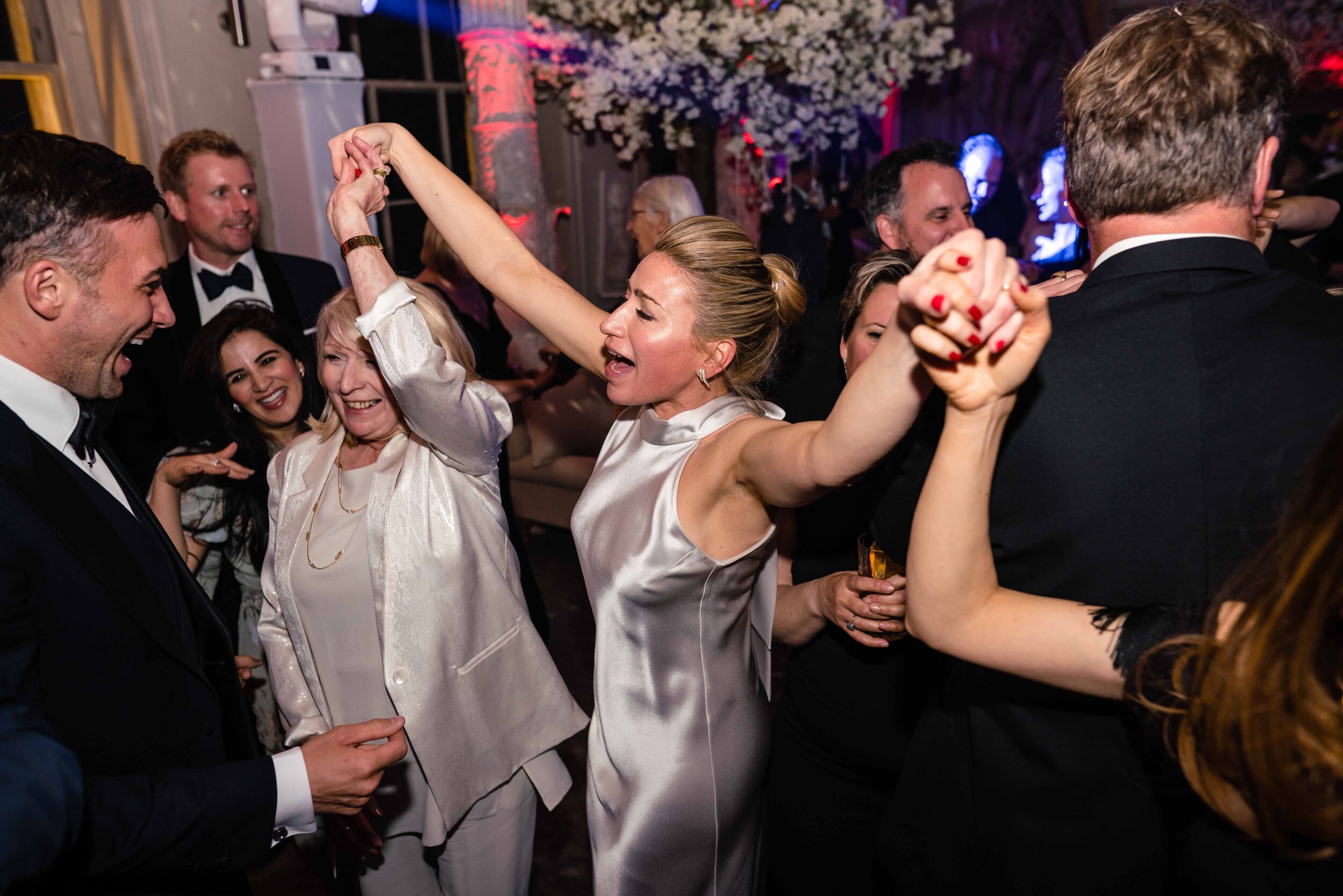 bride dancing arms in the air silver dress