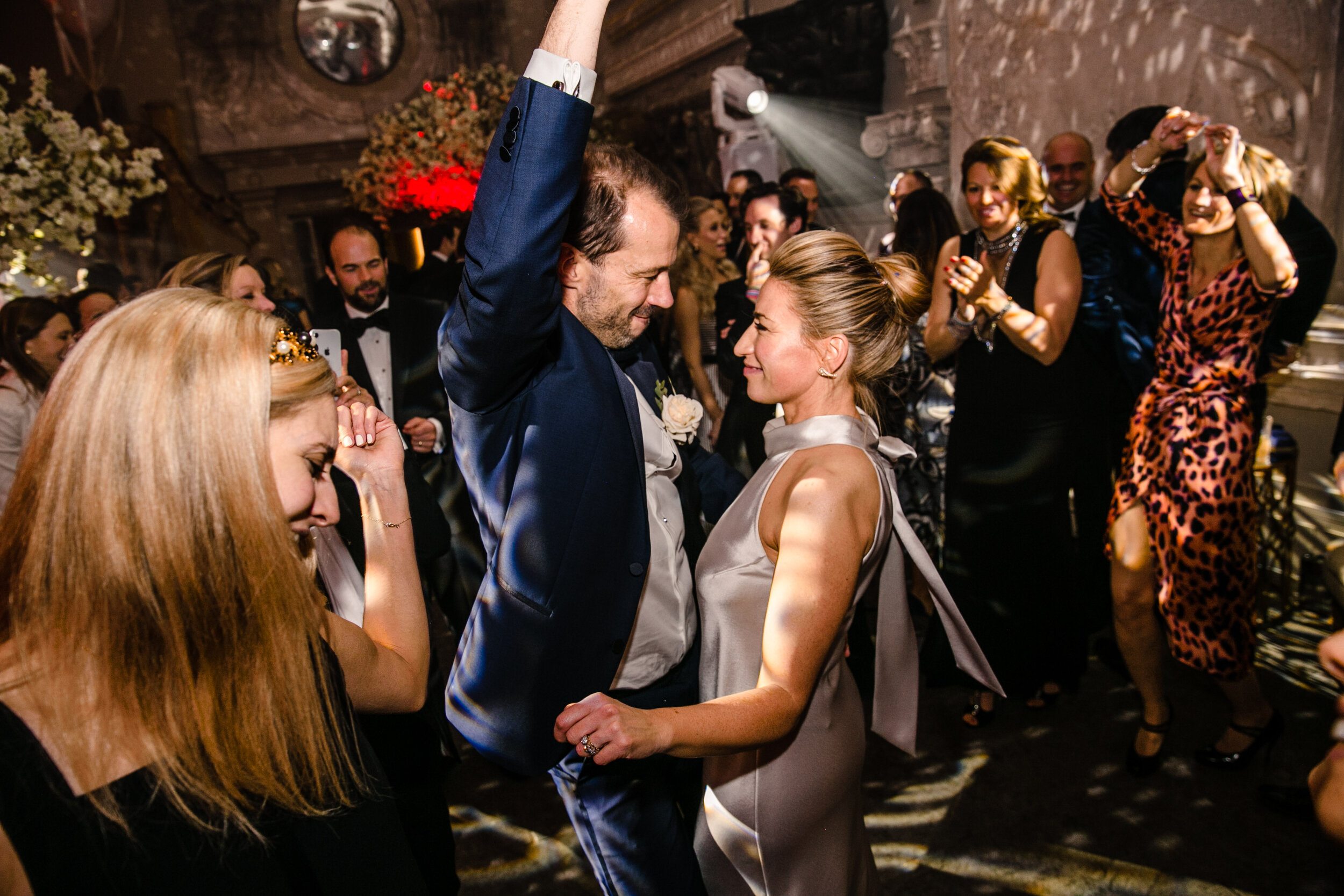 colourful dance floor with bride and groom dancing and groom punching the air