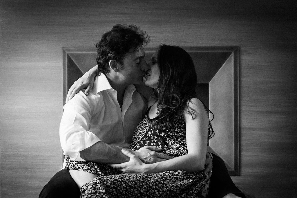 London pregnancy photography black and white in front of fireplace kissing