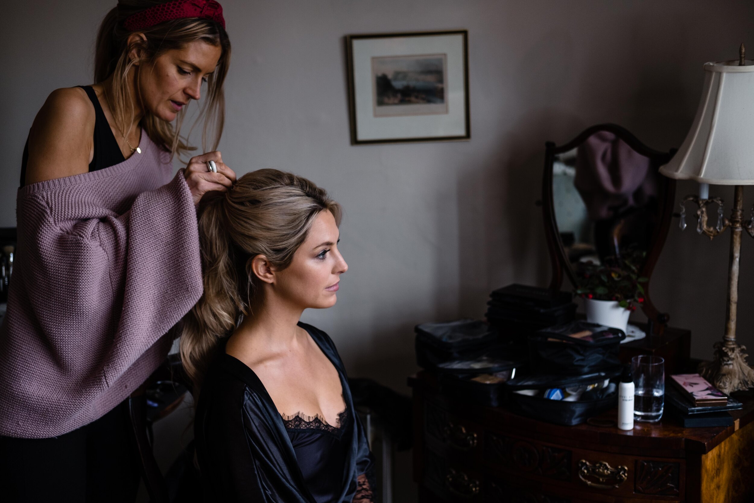 girl having hair done wearing black dressing gown