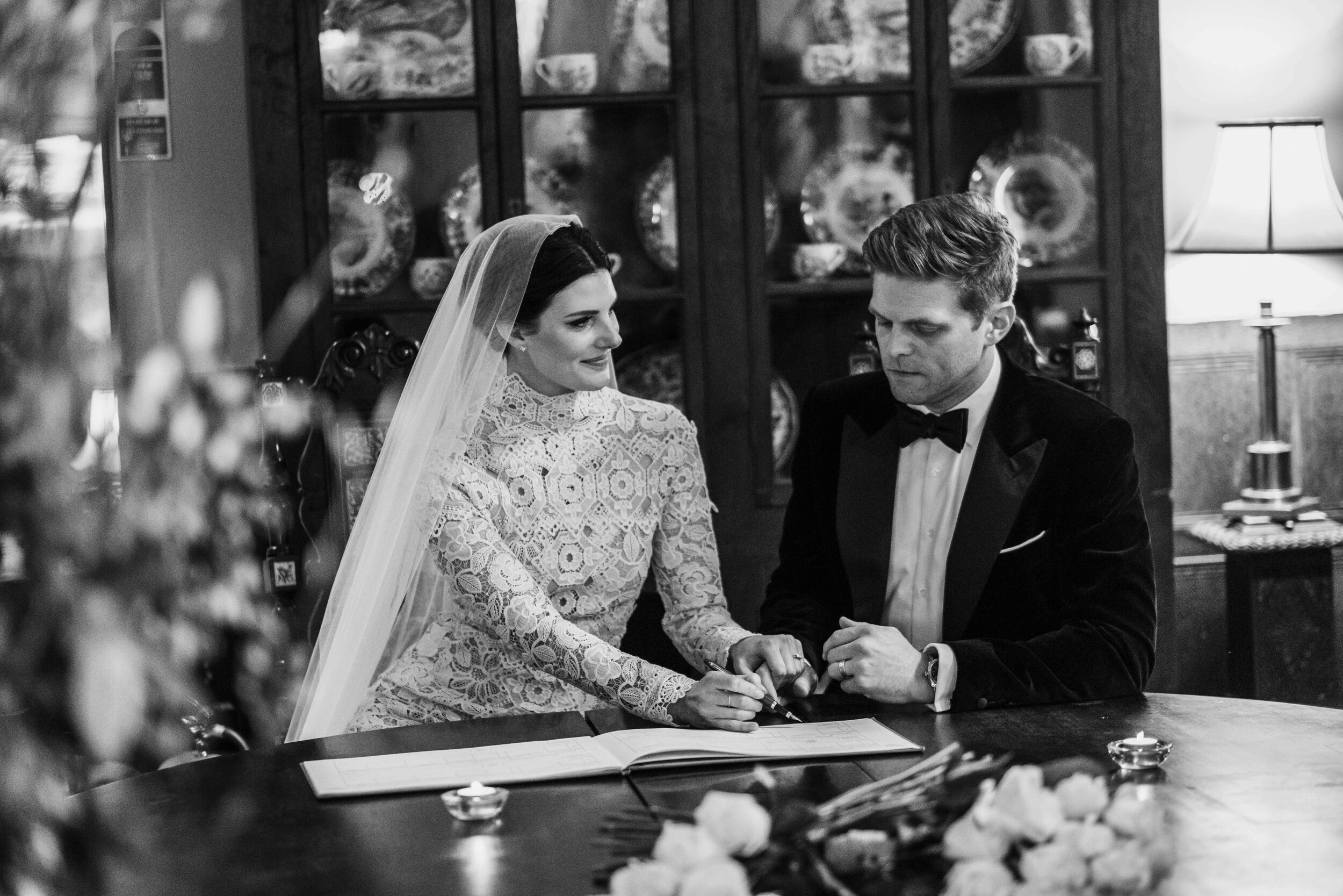 black and white bride and groom signing the register