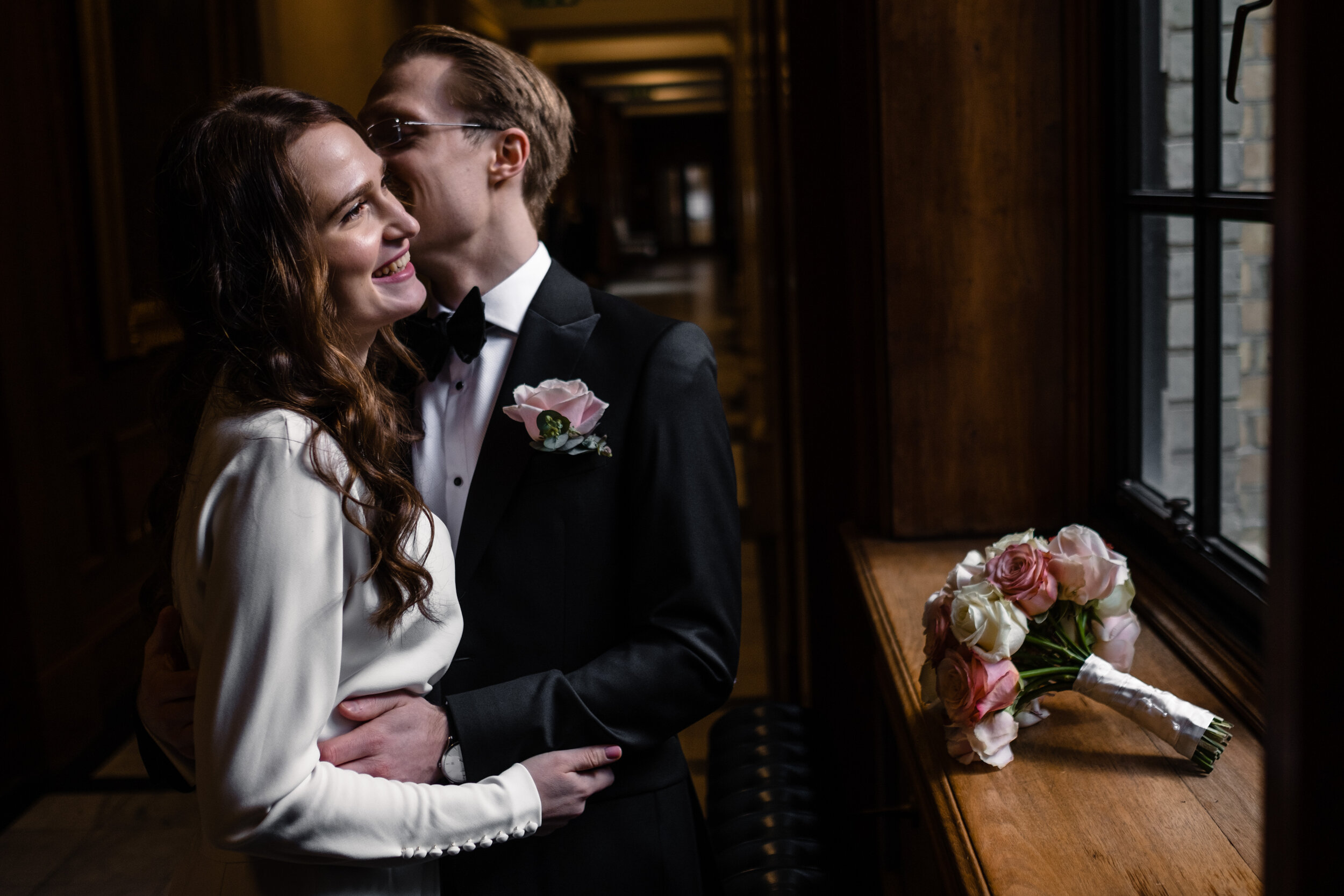 couple embracing by a window 