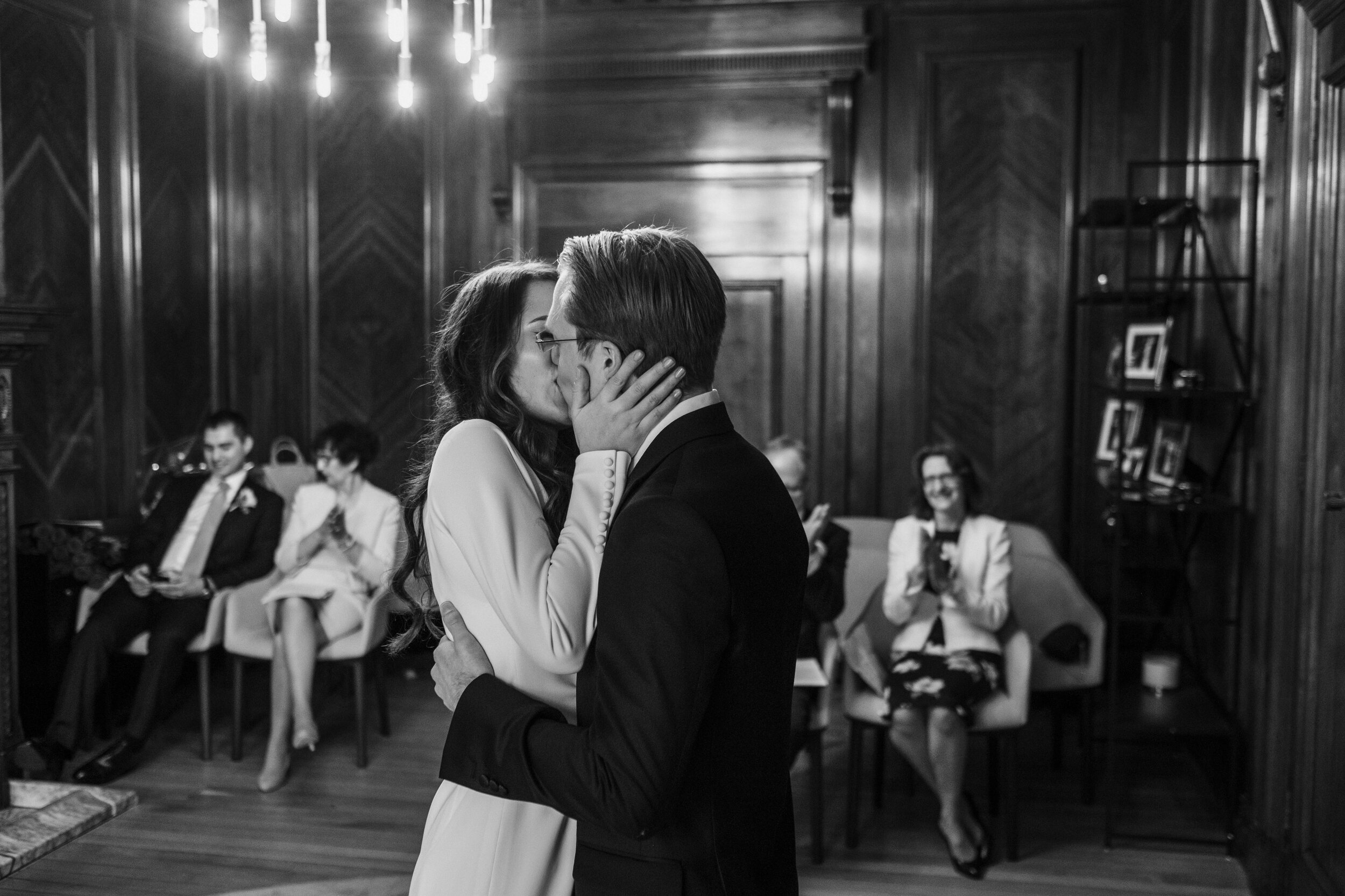 first kiss couple kissing in small ceremony room