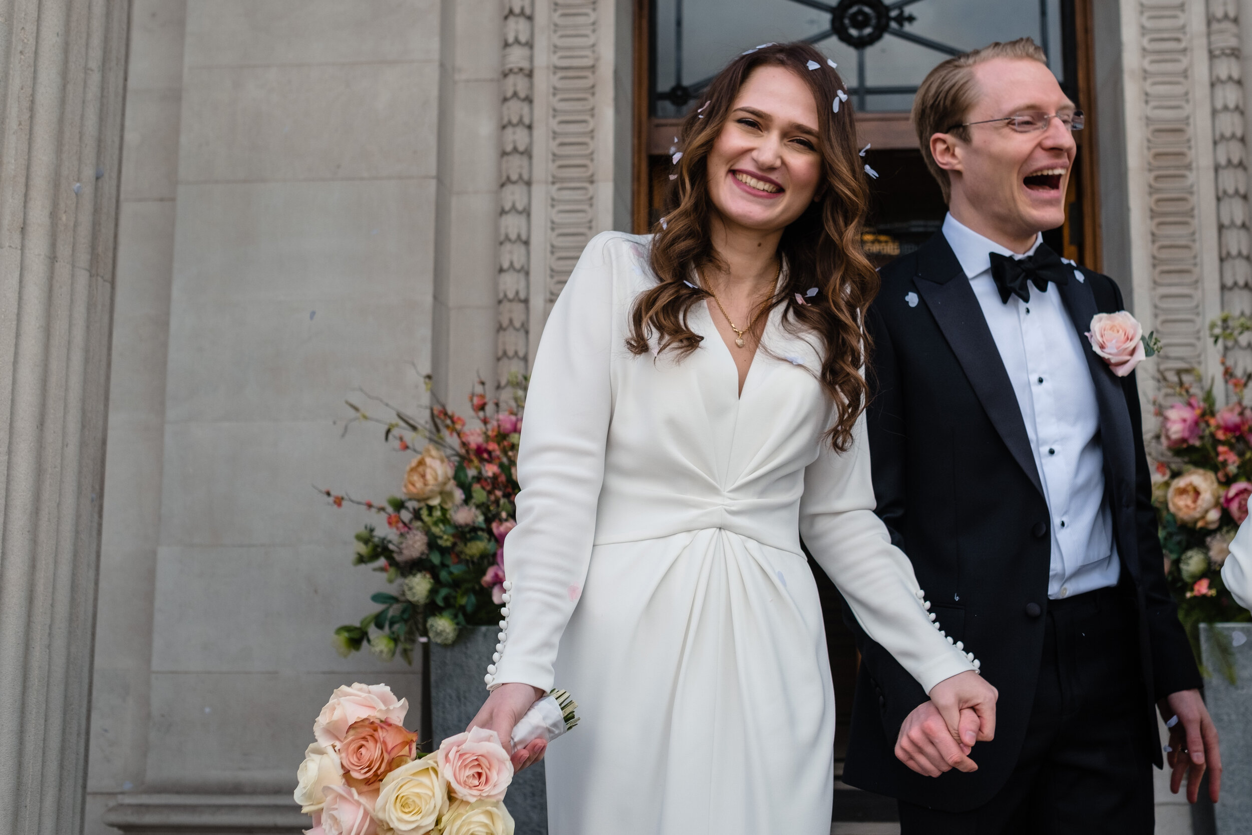 bride and groom on steps -  three quarter length