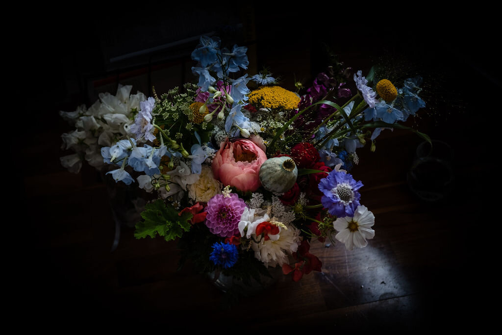 floral arrangement wedding bouquet against black backdrop