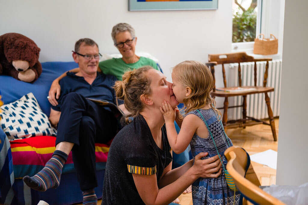 little girl kissing mum