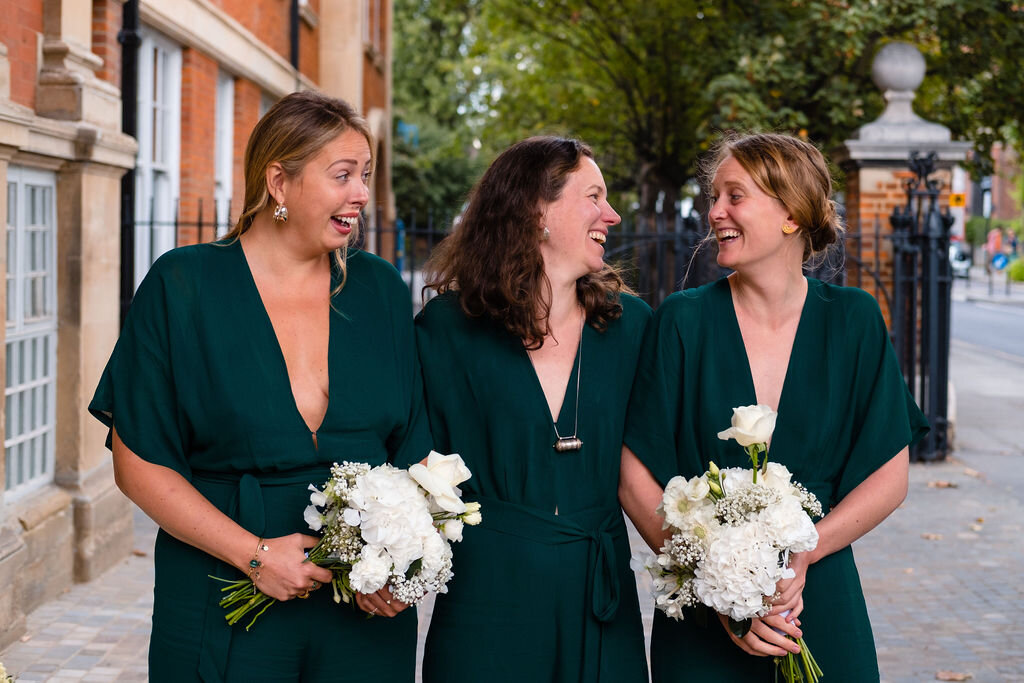 three bridesmaids wearing dark blue. dresses