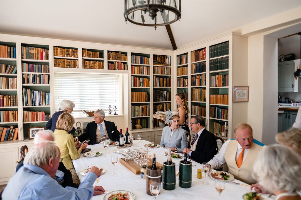 dining table in large house with guests seated for meal