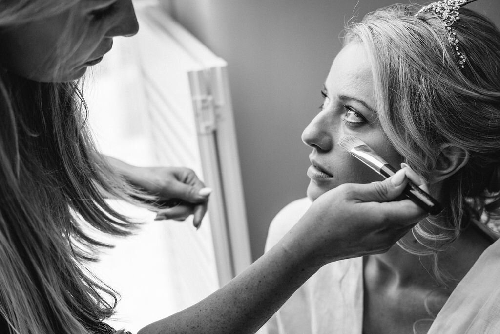 black and white close up bride having her make up done