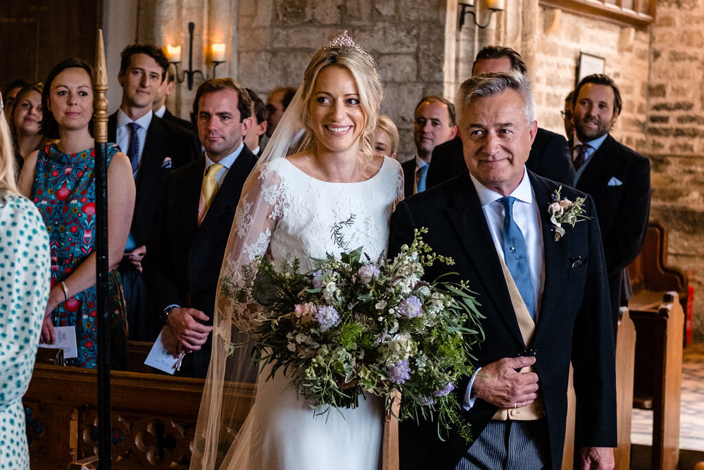 bride walking up aisle on arm of her father