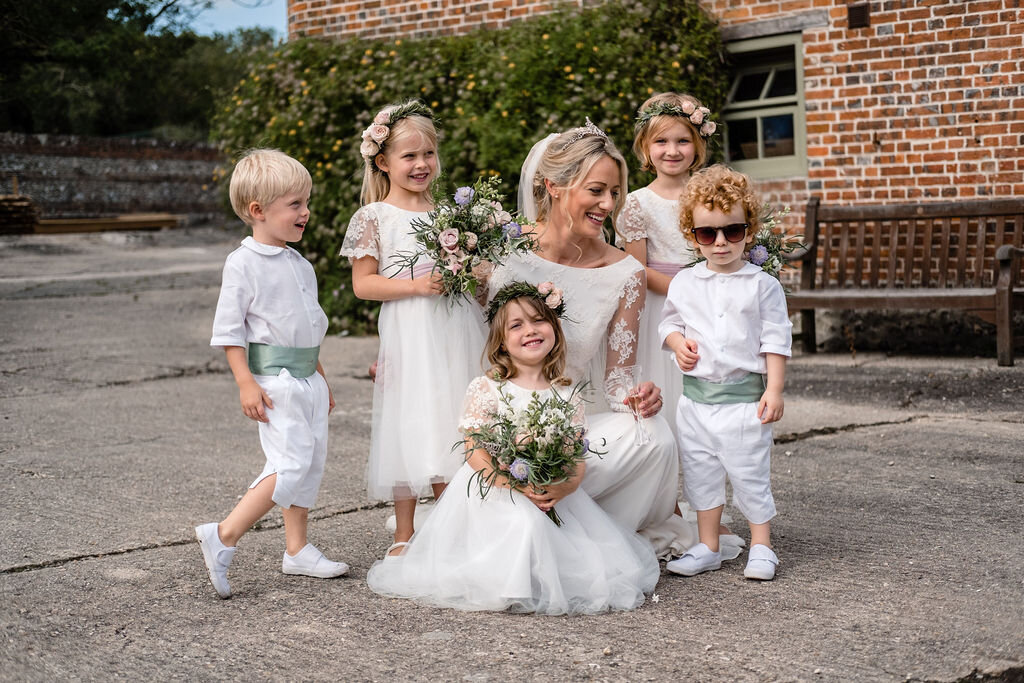 bride with flower girls and page boys