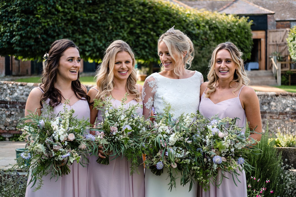 bride and bridesmaids with flower bouquet head and shoulders