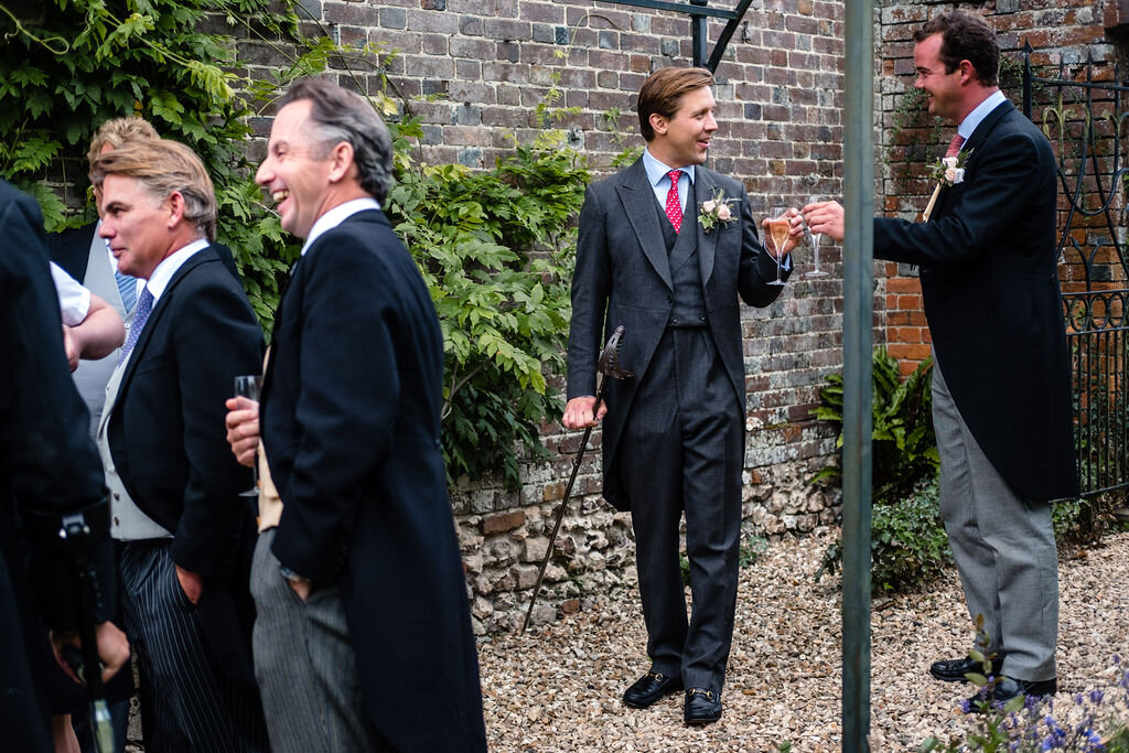men in suits at a wedding toasting