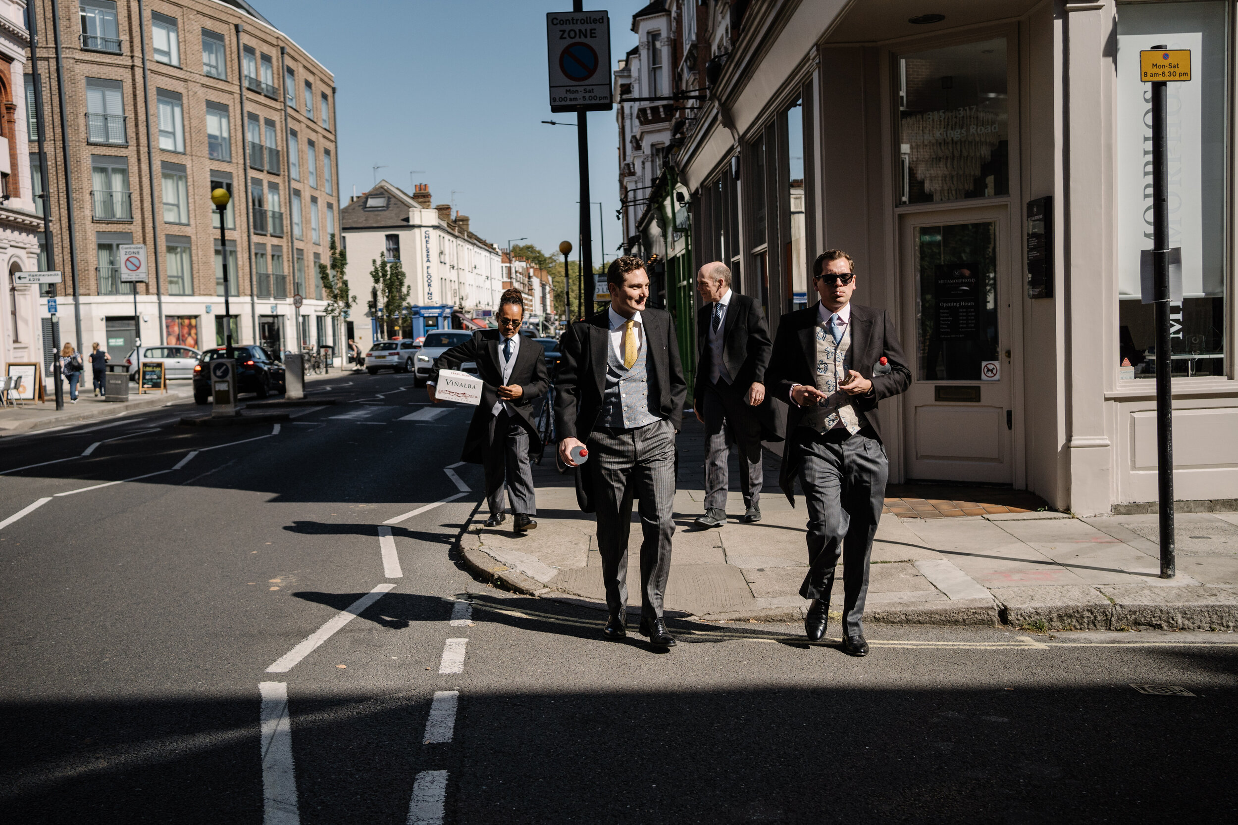 groom and ushers walking down a street in Fulham